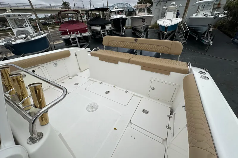 Slide: The Image of 2007 Century 3200 Center Console boat interior with tan seating and storage compartments. - 12