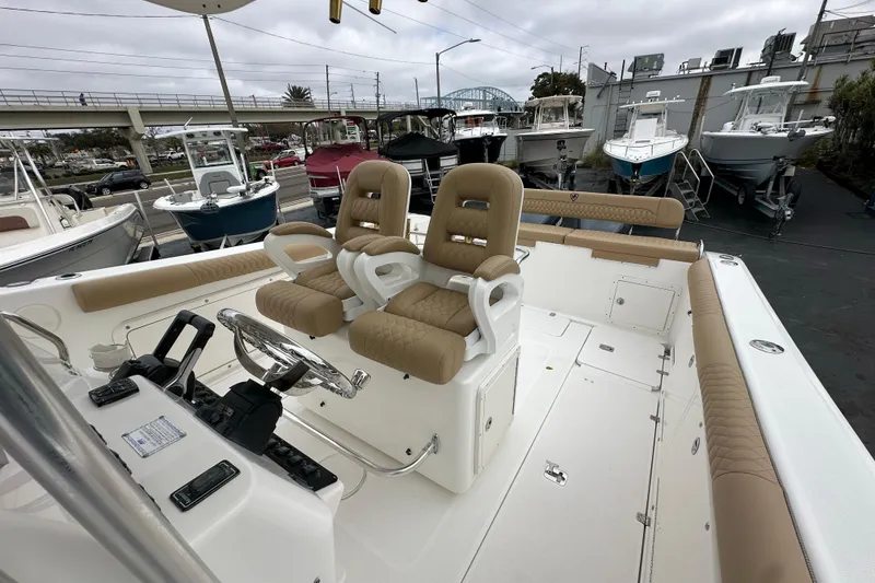 Slide: The Image of 2007 Century 3200 Center Console boat with dual seats and modern controls, docked at marina. - 17
