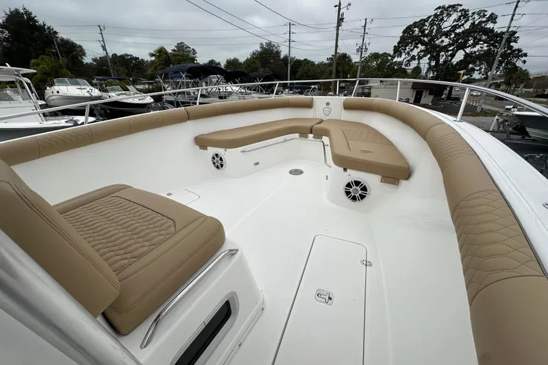 Slide: The Image of 2007 Century 3200 Center Console boat with tan cushioned seating and spacious deck. - 22