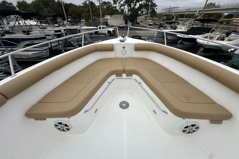 Slide: The Image of 2007 Century 3200 Center Console boat with tan cushioned seating in marina. - 24