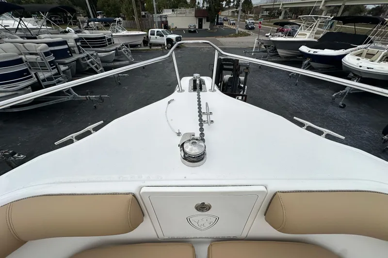 Slide: The Image of 2007 Century 3200 Center Console boat deck with anchor chain, surrounded by other boats. - 25