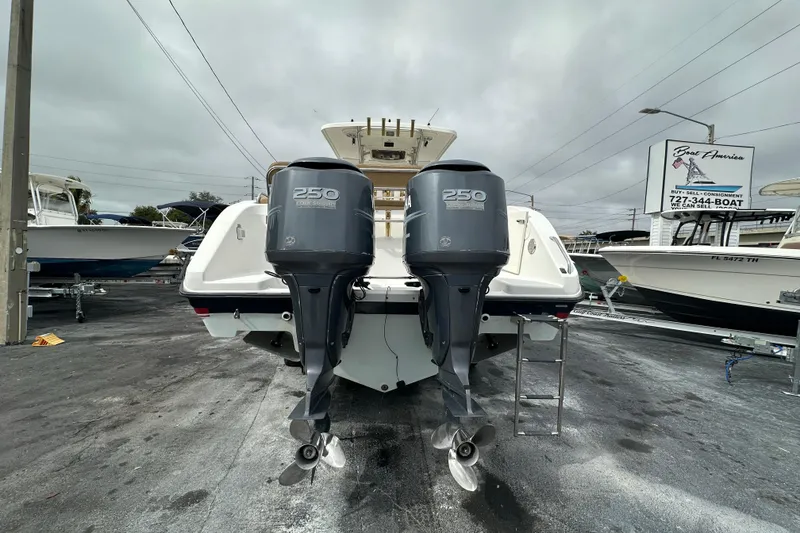 Slide: The Image of 2007 Century 3200 Center Console boat with twin 250 horsepower engines, docked outdoors. - 3