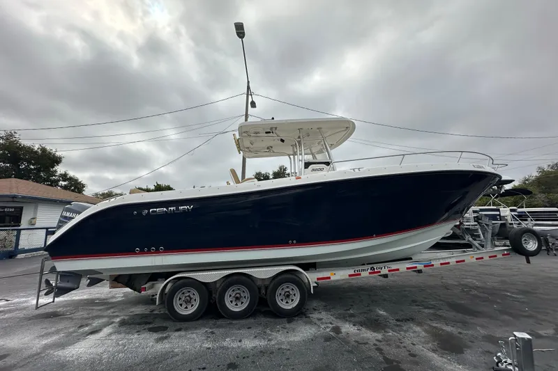 Slide: The Image of 2007 Century 3200 Center Console boat on a trailer, overcast sky background. - 5