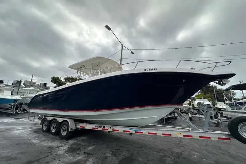 Slide: The Image of 2007 Century 3200 Center Console boat on trailer under cloudy sky. - 6