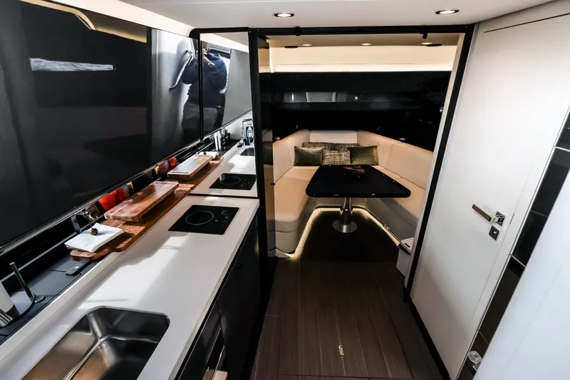 Slide: The Image of Luxurious interior of 2025 Azimut Verve 42 yacht with modern kitchen and cozy seating area. - 17