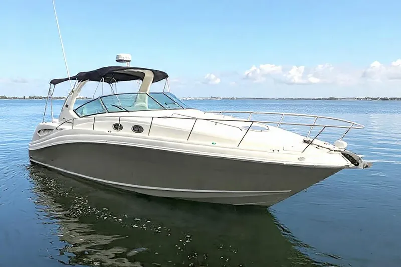 The Image of 2007 Sea Ray 340 Sundancer boat on calm water under clear blue sky. - 0