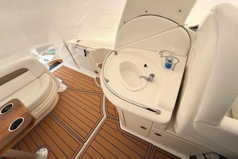Slide: The Image of 2007 Sea Ray 340 Sundancer interior with sink, seating, and wood-style flooring. - 13
