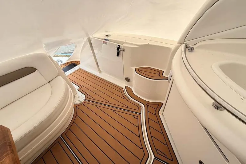 Slide: The Image of Interior of 2007 Sea Ray 340 Sundancer with teak flooring and white seating. - 14