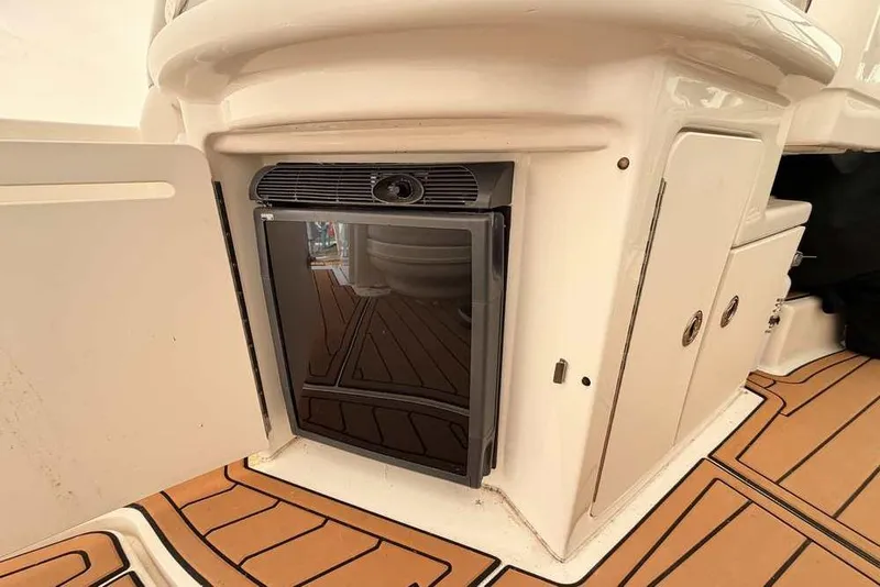Slide: The Image of 2007 Sea Ray 340 Sundancer interior with mini fridge and storage cabinets. - 15