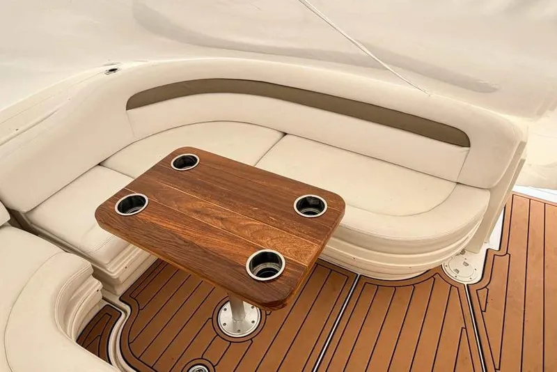 Slide: The Image of Luxurious seating area on 2007 Sea Ray 340 Sundancer with wooden table and cup holders. - 17