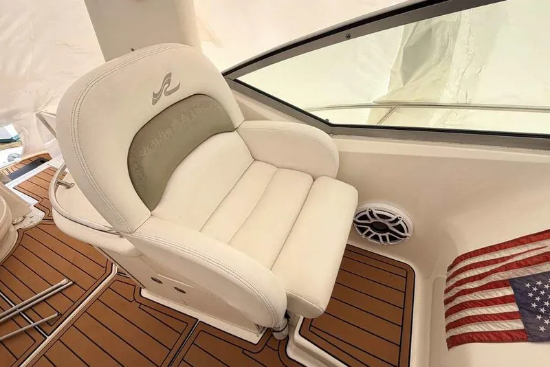 Slide: The Image of Captain's seat on 2007 Sea Ray 340 Sundancer boat with American flag and speaker. - 19