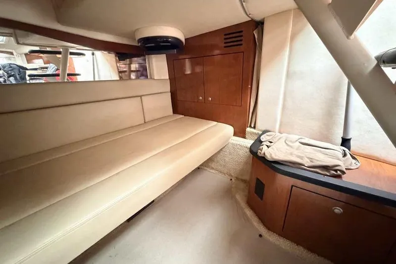 Slide: The Image of 2007 Sea Ray 340 Sundancer cabin interior with beige seating and wooden cabinetry. - 20