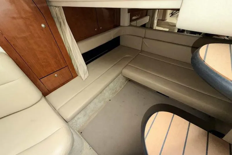 Slide: The Image of Interior of 2007 Sea Ray 340 Sundancer with beige seating and wooden cabinetry. - 21