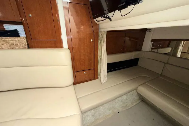Slide: The Image of Interior of 2007 Sea Ray 340 Sundancer with beige seating and wooden cabinetry. - 22