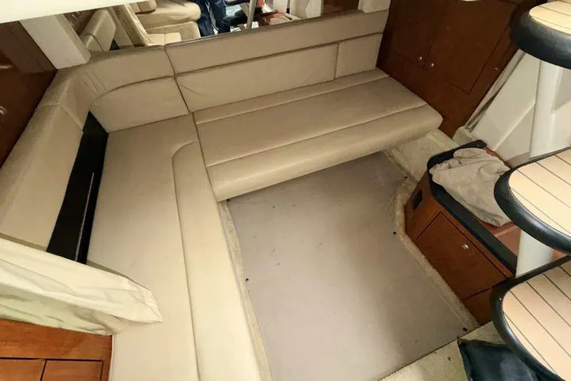 Slide: The Image of Interior of 2007 Sea Ray 340 Sundancer with beige seating and wooden cabinetry. - 23