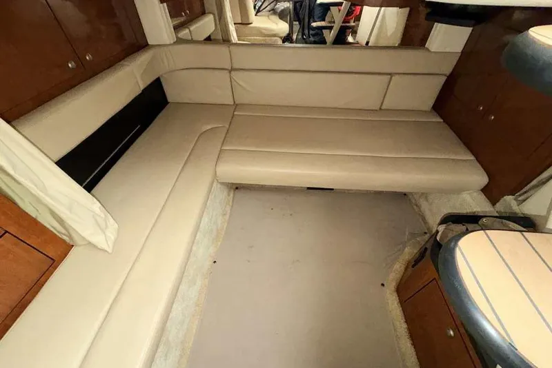 Slide: The Image of Interior of 2007 Sea Ray 340 Sundancer with beige seating and wooden cabinetry. - 24