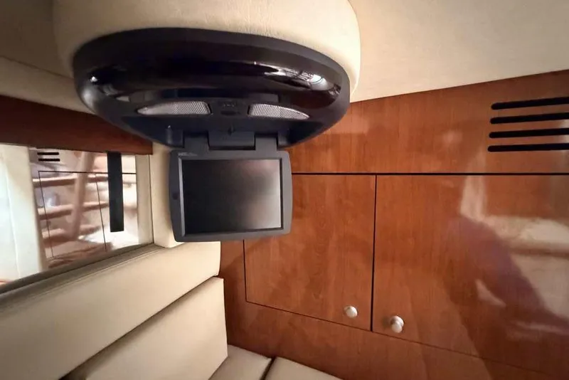 Slide: The Image of 2007 Sea Ray 340 Sundancer cabin with TV and wooden cabinetry. - 25