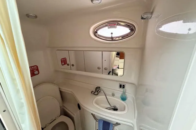 Slide: The Image of 2007 Sea Ray 340 Sundancer bathroom with sink, mirror, and porthole window. - 28
