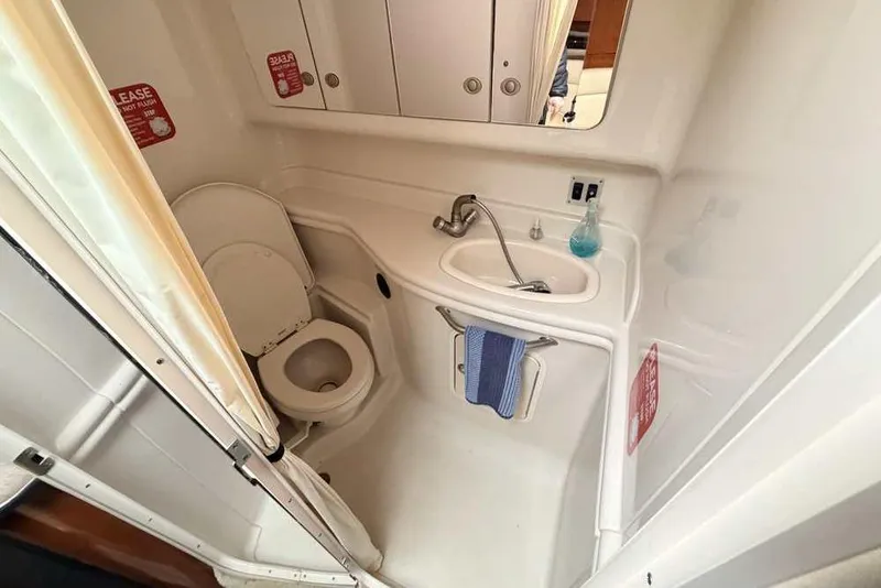 Slide: The Image of Compact bathroom in 2007 Sea Ray 340 Sundancer yacht with toilet and sink. - 29