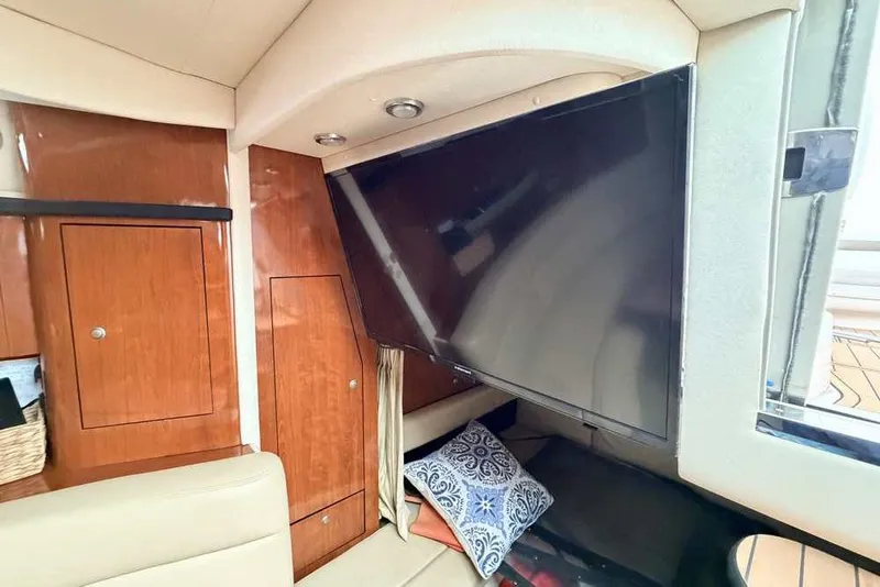 Slide: The Image of Interior of 2007 Sea Ray 340 Sundancer with TV and wooden cabinetry. - 30