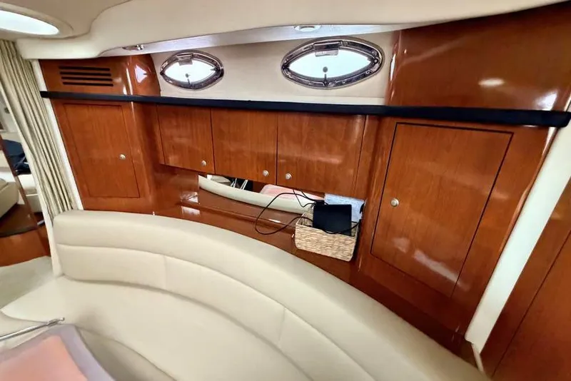 Slide: The Image of Luxurious 2007 Sea Ray 340 Sundancer cabin interior with wood cabinetry and porthole windows. - 31