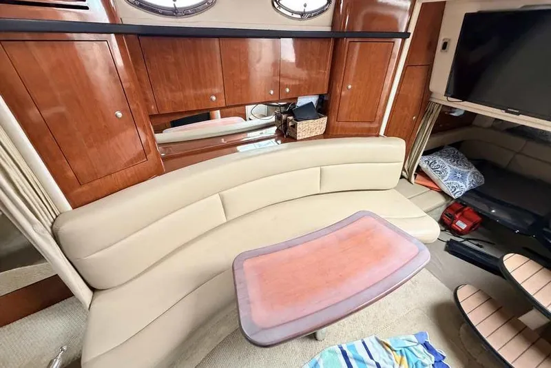 Slide: The Image of Luxurious interior of 2007 Sea Ray 340 Sundancer yacht with beige seating and wooden cabinetry. - 32