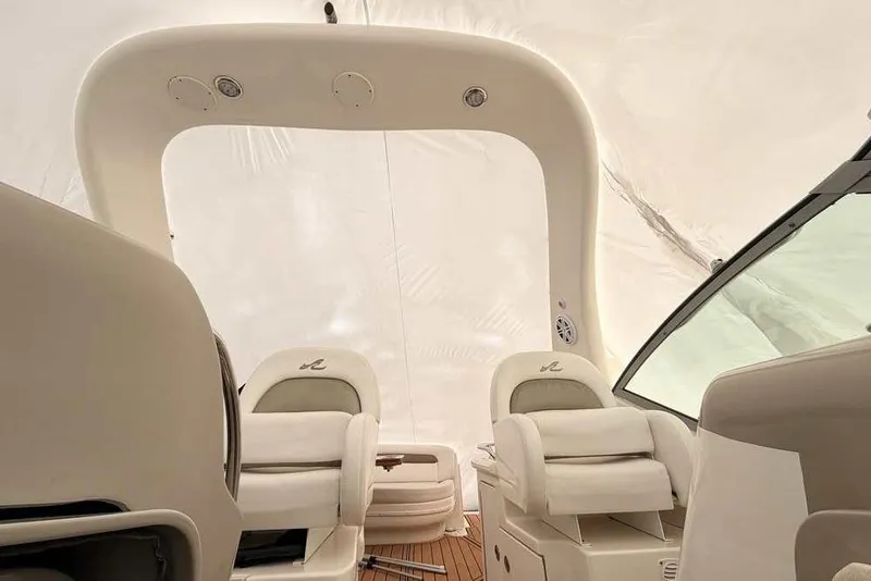 Slide: The Image of Interior view of 2007 Sea Ray 340 Sundancer boat with white seating and dashboard. - 42