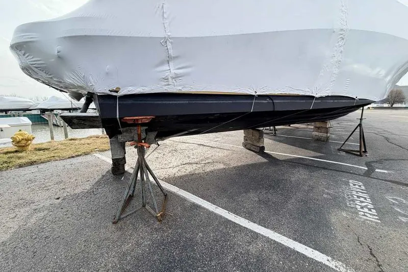 Slide: The Image of 2007 Sea Ray 340 Sundancer boat covered and supported on stands in a parking area. - 43
