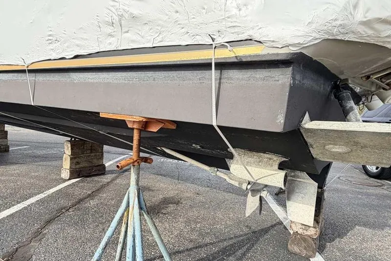 Slide: The Image of 2007 Sea Ray 340 Sundancer boat hull on stands in a parking lot. - 45