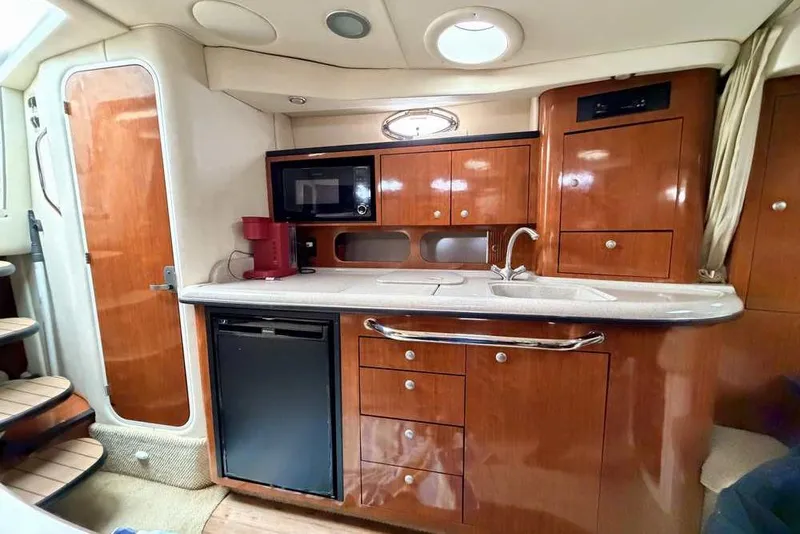 Slide: The Image of 2007 Sea Ray 340 Sundancer boat covered and supported on stands in a parking area. - 47