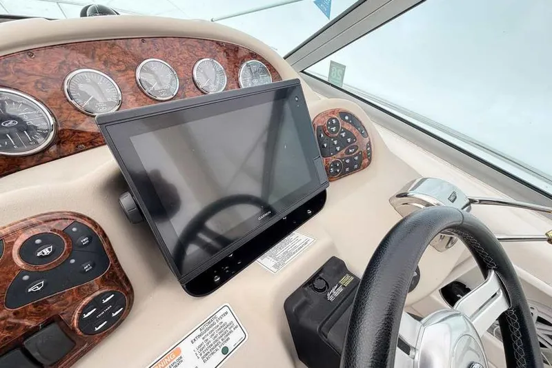 Slide: The Image of Dashboard of a 2007 Sea Ray 340 Sundancer boat with navigation controls. - 6