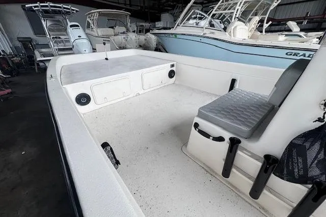 Slide: The Image of 2026 Carolina Skiff E24 DLX CC boat interior with seating and storage compartments. - 11