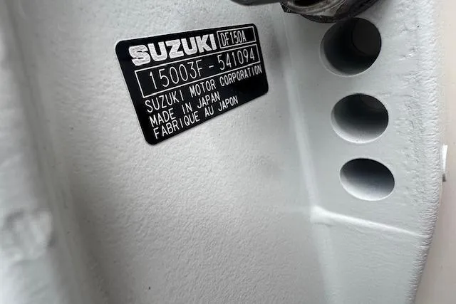 Slide: The Image of Label on Suzuki DF150A engine, made in Japan, on 2026 Carolina Skiff E24 DLX CC. - 4