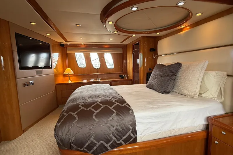 Slide: The Image of Luxurious bedroom interior of a 2005 Sunseeker 75 Yacht with elegant wood finishes. - 15