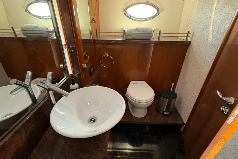 Slide: The Image of Luxurious bathroom in a 2005 Sunseeker 75 Yacht, featuring modern sink and toilet. - 31