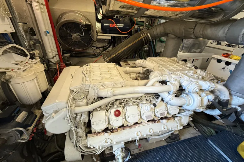 Slide: The Image of Engine room of a 2005 Sunseeker 75 Yacht, featuring a powerful marine engine. - 43