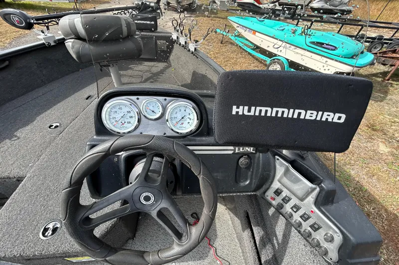 Slide: The Image of 2021 Lund 1675 Adventure SS boat dashboard with Humminbird electronics and steering wheel. - 11