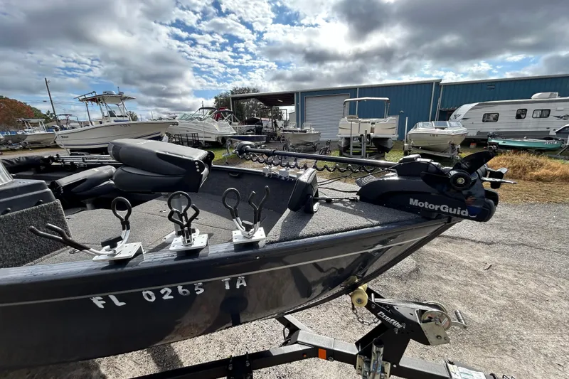 Slide: The Image of 2021 Lund 1675 Adventure SS boat with MotorGuide trolling motor in a marina setting. - 5
