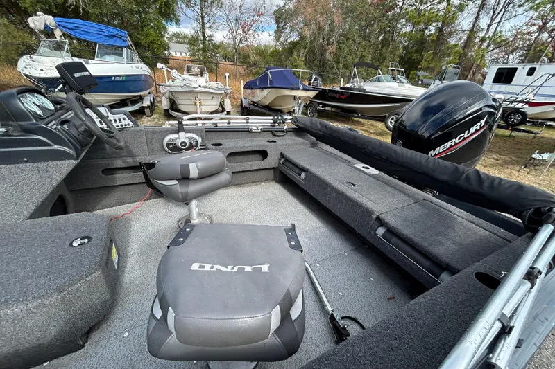 Slide: The Image of 2021 Lund 1675 Adventure SS boat interior with seating and Mercury outboard motor. - 8