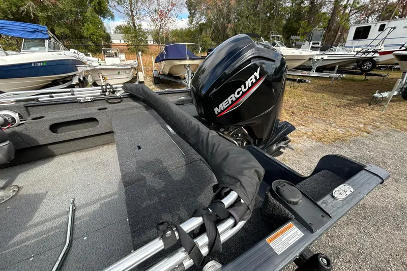 Slide: The Image of 2021 Lund 1675 Adventure SS boat with Mercury outboard motor in a marina setting. - 9