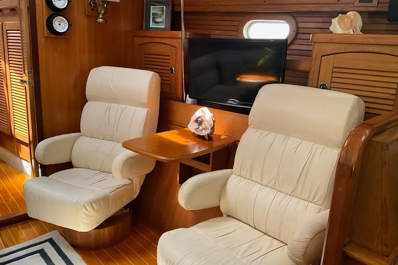 Slide: The Image of Luxurious interior of 2000 Catalina 470 yacht with plush seating and wooden accents. - 10