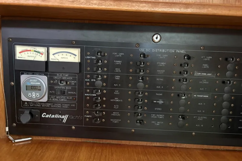 Slide: The Image of Electrical panel of a 2000 Catalina 470 yacht with various switches and gauges. - 13