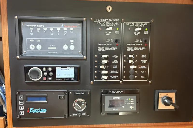 Slide: The Image of Control panel of a 2000 Catalina 470 yacht with various electronic systems and gauges. - 14