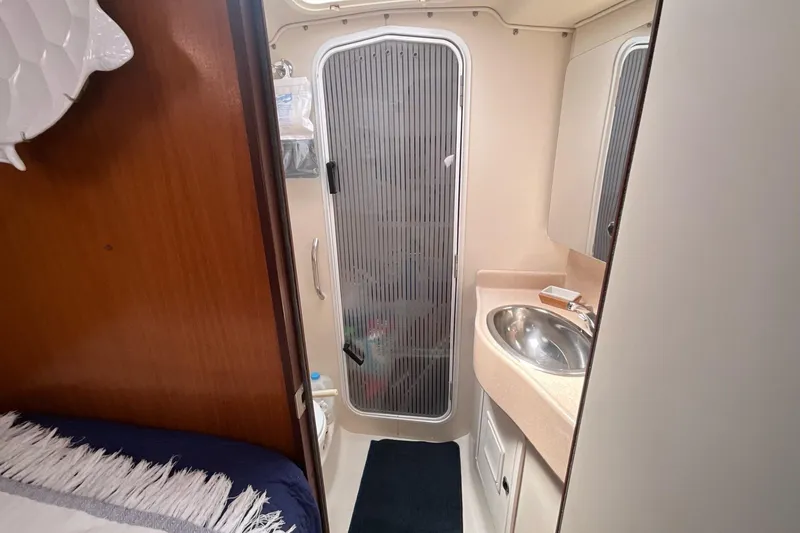 Slide: The Image of Catalina 470 yacht bathroom interior, featuring sink, shower, and wooden accents, year 2000 model. - 17