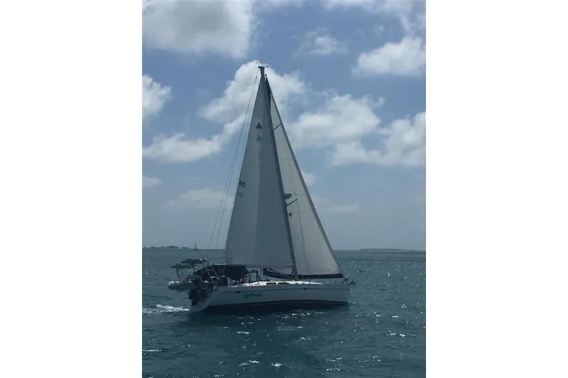 Slide: The Image of Sailing yacht Catalina 470, 2000 model, gliding on the ocean under a clear sky. - 3