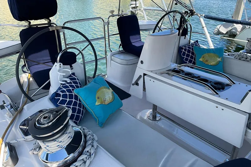 Slide: The Image of Cockpit of 2000 Catalina 470 sailboat with nautical-themed cushions and steering wheels. - 4
