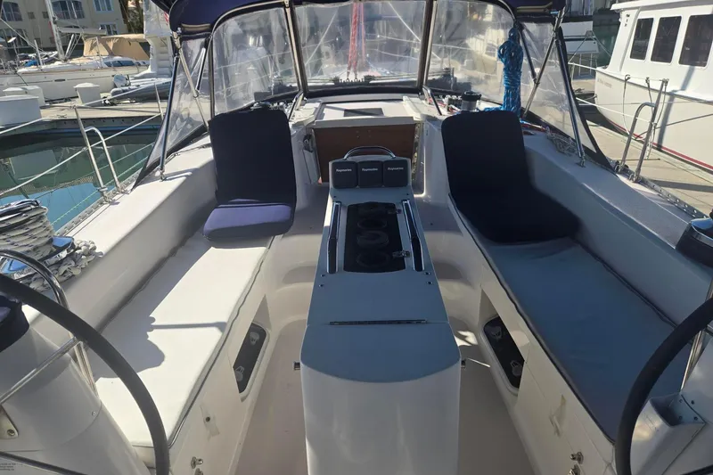 Slide: The Image of Cockpit of a 2000 Catalina 470 sailboat, featuring dual steering wheels and navigation equipment. - 5