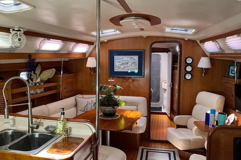 Slide: The Image of Interior of a 2000 Catalina 470 yacht with elegant wood finish and cozy seating. - 8