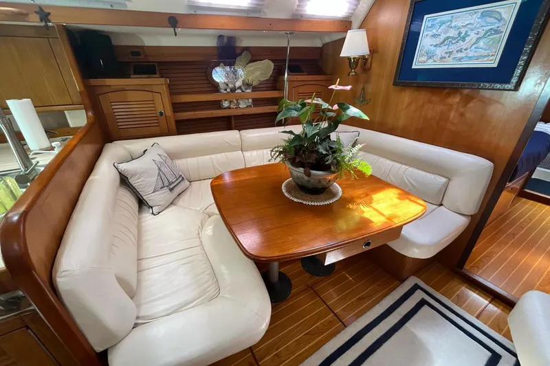 Slide: The Image of Luxurious interior of 2000 Catalina 470 yacht with elegant dining area and plush seating. - 9