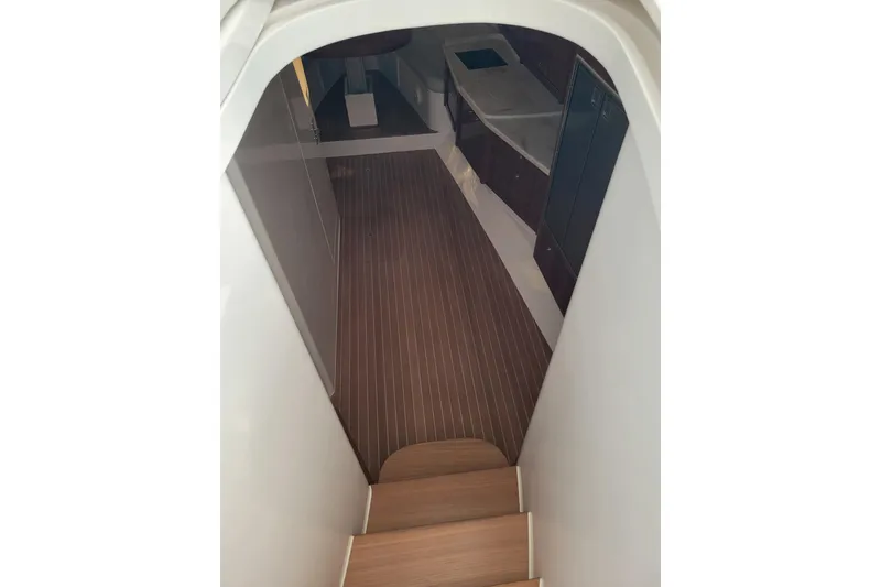 Slide: The Image of Interior view of 2016 Intrepid 475 Sport Yacht, featuring wooden flooring and modern design. - 13